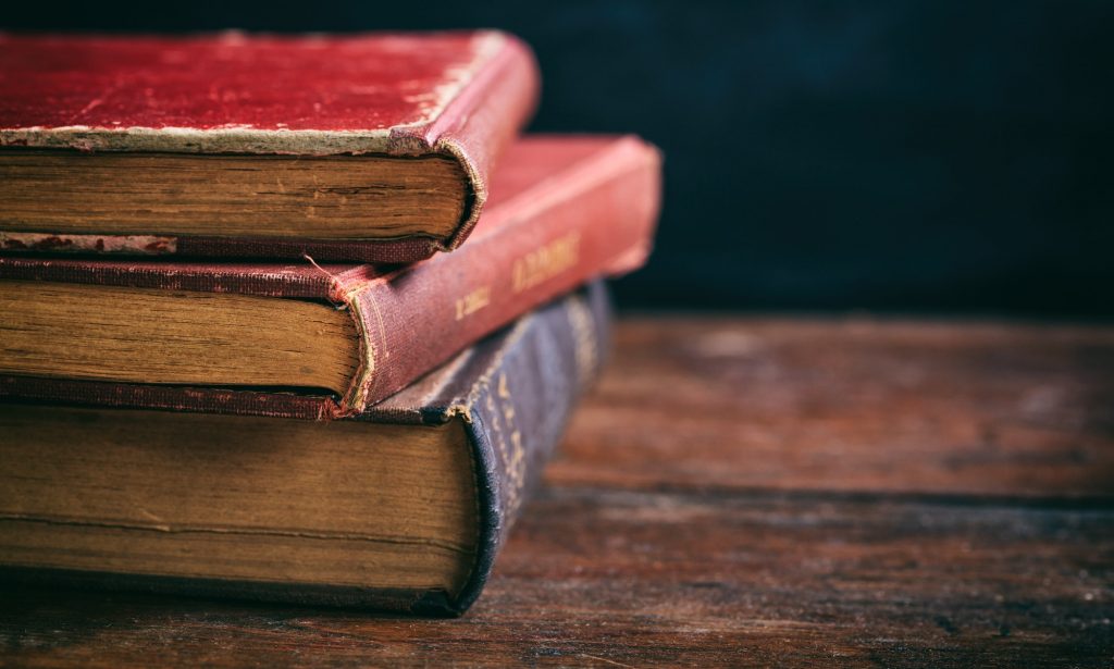 Vintage books stack on dark background